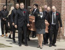 Family members carry the casket of singer-songwriter Gordon Lightfoot after a funeral service at St. Paul's United Church, in his hometown of Orillia, Ont., Monday, May 8, 2023. The legendary Canadian artist died May 1, at the age of 84 from natural causes. THE CANADIAN PRESS/Fred Thornhill