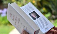 This illustration photo taken on June 23, 2020 shows a woman reading John Bolton's book "The Room Where it Happened" on the day of it's release in Los Angeles. - The Trump administration tried unsuccessfully to block publication of Bolton's book claiming it contained classified national security information.Former US national security advisor John Bolton said Sunday he thinks North Korean leader Kim Jong Un "gets a huge laugh" over US counterpart Donald Trump's perception of their relationship. Bolton spoke to ABC News for his first interview ahead of the Tuesday release of his tell-all book, which contains many damning allegations against Trump. (Photo by Chris DELMAS / AFP) (Photo by CHRIS DELMAS/AFP via Getty Images)