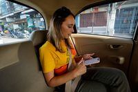 Lillian Smith, 30, from Mississippi, U.S., rides in a taxi as she goes on a tour in Bangkok, Thailand May 13, 2023. REUTERS/Jorge Silva