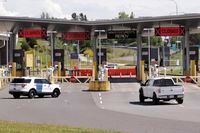 In this photo taken Sunday, May 17, 2020, a truck from Canada heads to the single open lane heading into the U.S. at the Peace Arch border crossing in Blaine, Wash. Canada and the U.S. have agreed to extend their agreement to keep the border closed to non-essential travel to June 21 during the coronavirus pandemic. The restrictions were announced on March 18, were extended in April and now extended by another 30 days. (AP Photo/Elaine Thompson)