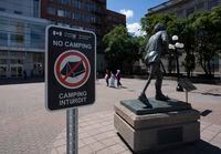 A federal sign indicates No Camping in a downtown square next to the Terry Fox statue across from the Parliament buildings, Wednesday, July 27, 2022 in Ottawa.  THE CANADIAN PRESS/Adrian Wyld