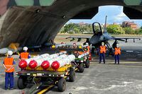 Military personnel stand next to U.S. Harpoon A-84, anti-ship missiles and AIM-120 and AIM-9 air-to-air missiles prepared for a weapon loading drills in front of a U.S. F-16V fighter jet at the Hualien Airbase in Taiwan's southeastern Hualien county, Wednesday, Aug. 17, 2022. China announced sanctions on Friday, Sept. 16, 2022, against the CEOs of American defense contractors Raytheon and Boeing Defense over a major U.S. arms sale to rival Taiwan. (AP Photo/Johnson Lai, File)