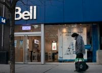 A pedestrian walking past a Bell store on Queen St. West in Toronto in December of 2020.