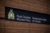 The RCMP logo is seen outside Royal Canadian Mounted Police "E" Division Headquarters, in Surrey, B.C., on Friday April 13, 2018. Mounties in British Columbia's Comox Valley say they have found the vehicle that was involved in a fatal hit and run earlier this week. THE CANADIAN PRESS/Darryl Dyck