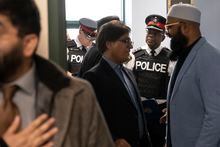 Deputy Chief Robertson Rouse of the York Regional Police (second right) speaks to members of the Islamic Society of Markham before a news conference, in Markham, Ont. on Monday, April 10, 2023. Police and members of the Islamic community provided updates on the recent incident in which a man allegedly drove a vehicle directly toward a worshipper at a Markham mosque, yelled threats, and uttered racial slurs. THE CANADIAN PRESS/Chris Young 