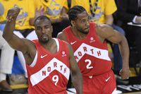 Toronto Raptors centre Serge Ibaka (9) celebrates his three point basket as Toronto Raptors forward Kawhi Leonard (2) looks on against the Golden State Warriors during second half basketball action in Game 4 of the NBA Finals in Oakland, California on Friday, June 7, 2019. THE CANADIAN PRESS/Frank Gunn