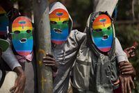 FIle - Kenyan members and supporters of the LGTB community wear masks to preserve their anonymity as they stage a protest in Nairobi, Kenya, Monday, Feb. 10, 2014. Police in Kenya are investigating the death of LGBT activist Edwin Chiloba, whose body was found on Wednesday, Jan. 4, 2023, stuffed in a metal box on a road in Uasin Gishu County, in the west of the country. (AP Photo/Ben Curtis, File)