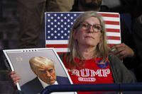 An attendee listens as former President Donald Trump speaks at a campaign rally, Saturday Dec. 16, 2023, in Durham, N.H. (AP Photo/Reba Saldanha)