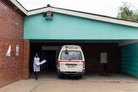 A nurse walks past one of the only three working ambulances at the Zengeza Clinic, in Chitungwiza, Zimbabwe, on March 20, 2020.