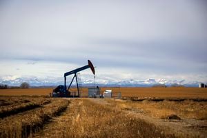 A Bonavista pump jack in a farmers field with the Rocky Mountains for a backdrop just north of Calgary, Alberta, October 24, 2019.