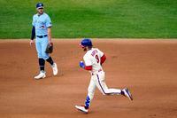 Philadelphia Phillies' Bryce Harper, right, rounds the bases past Toronto Blue Jays third baseman Travis Shaw after hitting a two-run home run off pitcher Robbie Ray during the fifth inning of the first baseball game in a doubleheader, Friday, Sept. 18, 2020, in Philadelphia.