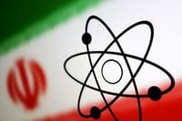 FILE PHOTO: Atom symbol and Iran flag are seen in this illustration, July 21, 2022. REUTERS/Dado Ruvic/Illustration