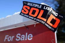 A real estate sold sign is shown outside a house in Vancouver, Tuesday, Jan.3, 2017. There are a pair of key reports this week expected on Monday that will help economists gauge the health of the housing market in Canada. THE CANADIAN PRESS/Jonathan Hayward