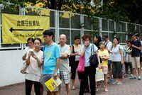 People queue as they wait to cast their votes for the Legislative Council election in Hong Kong, China, in a Sept. 4, 2016, file photo.
