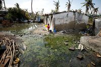 A child stands amongst pools of stagnant water in Beira, Mozambique, March 27, 2019.