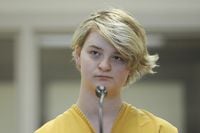 FILE - Denali Brehmer stands at her arraignment in the Anchorage Correctional Center in Anchorage, Alaska, on June 9, 2019. Brehmer, 24, was sentenced earlier this week to 99 years in prison for orchestrating the death of a developmentally disabled woman in a murder-for-hire plot, hoping to cash in on a $9 million offer from a Midwestern man purporting to be a millionaire.(Bill Roth/Anchorage Daily News via AP, File)