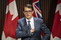 Ontario Labour Minister Monte McNaughton takes to the podium during a news conference in Toronto on Wednesday April 28, 2021. Ontario is proposing to strengthen rules around mass layoffs to include greater protections for employees who work remotely.&nbsp;THE CANADIAN PRESS/Chris Young