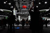Visitors take pictures of the Huawei stand on the opening day of the MWC (Mobile World Congress) in Barcelona on February 28, 2022. - The world's biggest mobile fair is held from February 28 to March 3, 2022. (Photo by Pau BARRENA / AFP) (Photo by PAU BARRENA/AFP via Getty Images)