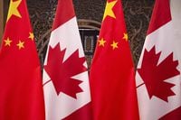 Flags of Canada and China are shown prior to a meeting of Canadian Prime Minister Justin Trudeau and Chinese President Xi Jinping at the Diaoyutai State Guesthouse in Beijing on Dec. 5, 2017. The Liberal government has directed a state-owned Chinese telecommunications firm to divest its stake in a Canadian subsidiary over national security concerns, prompting a court challenge of the order. THE CANADIAN PRESS/AP, Fred Dufour, Pool Photo