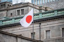 The Japanese national flag is seen at the Bank of Japan (BoJ) headquarters in Tokyo on February 14, 2023. - Economics professor Kazuo Ueda was nominated on February 14 as the Bank of Japan's next governor, tasked with navigating a way forward after a decade of extraordinary monetary easing. (Photo by Yuichi YAMAZAKI / AFP) (Photo by YUICHI YAMAZAKI/AFP via Getty Images)