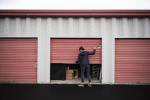 Sam Stiles, Operations Manager at Shelter Movers Ottawa, closes a storage unit containing clients' belongings, in Ottawa, on Thursday, June 3, 2021. (Justin Tang for The Globe and Mail)