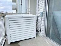 Balcony-mounted heat pumps at an installation in Mississauga, Ont. The low-carbon HVAC system  provides both heating and cooling and uses a quarter to a third of the electricity of baseboards heaters. 