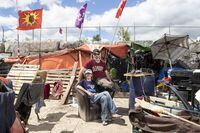 Will House and Jen Draper are photographed outside their home at a large homeless encampment, in Kitchener, Ont., on Monday June 27, 2022. THE CANADIAN PRESS/Chris Young