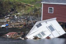 Buildings sit in the water along the shore following hurricane Fiona in Rose Blanche-Harbour le Cou, N.L. on Tuesday, Sept. 27, 2022. THE CANADIAN PRESS/Frank Gunn