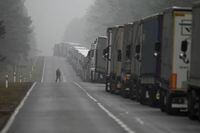 Trucks queue at motorway 65 on their way to the Polish-Belarusian border between Bialystok and Bobrowniki, Poland, Sunday, Nov. 14, 2021. (AP Photo/Matthias Schrader)