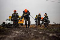 Workers repair high-voltage power lines cut by recent missile strikes near Odessa on December 7, 2022, amid the Russian invasion of Ukraine. - A new barrage of Russian strikes on December 5, left several Ukrainian cities without power, including the eastern city of Sumy and the southern city of Mykolaiv, according to officials. In Odessa, the water services operator said "there is no water supply anywhere" and officials in the central city of Kryvyi Rig said "parts of the city are cut off from electricity, several boiler and pumping stations are disconnected." (Photo by OLEKSANDR GIMANOV / AFP) (Photo by OLEKSANDR GIMANOV/AFP via Getty Images)