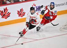 HALIFAX, CANADA - JANUARY 05:  Connor Bedard #16 of Team Canada skates the puck against Eduard Sale #28 of Team Czech Republic during overtime in the gold medal round of the 2023 IIHF World Junior Championship at Scotiabank Centre on January 5, 2023 in Halifax, Nova Scotia, Canada.  (Photo by Minas Panagiotakis/Getty Images)