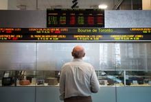 Canada's main stock index edged higher in late-morning trading as the loonie moved up against the U.S. dollar. A man watches the financial numbers at the TMX Group in Toronto's financial district in a May 9, 2014 photo. THE CANADIAN PRESS/Darren Calabrese