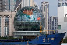 FILE PHOTO: A Chinese flag flutters on a ship in front of a globe in Shanghai, China August 2, 2022. REUTERS/Aly Song