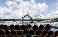 Pipe sections for the Trans Mountain pipeline are unloaded in Edson, Alta., Tuesday, June 18, 2019. North America's polarizing pipeline battles have seen many venues — from the Prime Minister's Office and the U.S. State Department to the windswept plains of Nebraska and Minnesota to judge's chambers on both sides of the Canada-U.S. border. THE CANADIAN PRESS/Jason Franson