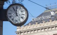 FILE PHOTO: A clock is seen near the logo of Swiss bank Credit Suisse at the Paradeplatz square in Zurich, Switzerland October 5, 2022. REUTERS/Arnd Wiegmann/File Photo