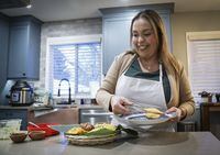 Ana Maria Moreno, who runs Valluno's Colombian Street Food and More from her home, makes empanadas in Calgary, Alta., Wednesday, Dec. 1, 2021.THE CANADIAN PRESS/Jeff McIntosh