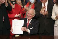 South Carolina Gov. Henry McMaster holds up a bill banning almost all abortions in the state after he signed it into law on Feb. 18, 2021, in Columbia, S.C. An appellate court is preparing to hear arguments over a lawsuit challenging South Carolina’s abortion law, as states around the country await U.S. Supreme Court action in another case that could dramatically limit abortion rights overall. (AP Photo/Jeffrey Collins, file)