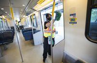 Cleaners demonstrate how they disinfect train cars in Vancouver on May 21, 2020. A tenative agreement has been reached to keep a key commuter link rolling between Richmond and Vancouver.