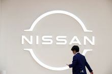 FILE PHOTO: A man walks in front of the Nissan logo at Nissan Gallery in Yokohama, Japan November 29, 2021. REUTERS/Androniki Christodoulou