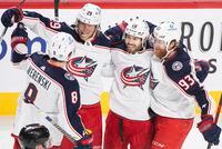Columbus Blue Jackets' Patrik Laine (29) celebrates with teammates after scoring against the Montreal Canadiens during third period NHL hockey in Montreal, Saturday, February, 12, 2022. THE CANADIAN PRESS/Graham Hughes