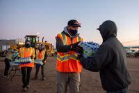 City of Iqaluit staff and volunteers hand out bottles of water for residents on October 15, 2021. 