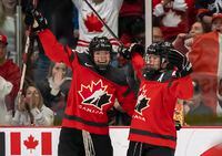 Canada defender Claire Thompson (42) congratulates forward Blayre Turnbull (40) after her goal against Sweden during first period quarterfinal IIHF Women’s World Hockey Championship hockey action in Brampton, Ont., Thursday, April 13, 2023. THE CANADIAN PRESS/Frank Gunn