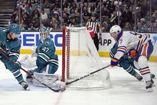 San Jose Sharks goaltender James Reimer (47) blocks a shot by Edmonton Oilers center Connor McDavid, right, during the third period of an NHL hockey game in San Jose, Calif., Saturday, April 8, 2023. (AP Photo/Godofredo A. Vásquez)