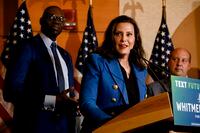 Michigan Gov. Gretchen Whitmer, with Lt. Gov. Garlin Gilchrist, left, delivers her victory speech the day after Election Day at the MotorCity Casino in Detroit, Nov. 9, 2022. (Brittany Greeson/The New York Times)