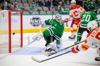 Feb 1, 2022; Dallas, Texas, USA; Calgary Flames defenseman Oliver Kylington (58) scores the game winning goal against Dallas Stars goaltender Jake Oettinger (29) during the third period at the American Airlines Center. Mandatory Credit: Jerome Miron-USA TODAY Sports