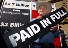 Alberta Premier Ralph Klein announces in Calgary, Monday, July 12, 2004, that Alberta has paid its $3.7 billion debt. The Klein government inherited over $22-billion in debt in 1993 and will be the only debt free province in the country. (CP PHOTO/Jeff McIntosh)