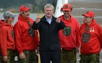 Prime Minister Stephen Harper is greeted by a group of Canadian Rangers as he arrives in Whitehorse, Yukon on Sunday, August 18, 2013.Whitehorse is Harper's first stop on his annual northern Canada tour. THE CANADIAN PRESS/Sean Kilpatrick
