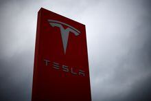 FILE PHOTO: The logo of Tesla is pictured at a dealership in Chambourcy, near Paris, France, December 15, 2021. REUTERS/Gonzalo Fuentes