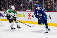 Mar 14, 2023; Vancouver, British Columbia, CAN; Dallas Stars defenseman Joel Hanley (44) defends against Vancouver Canucks forward Elias Pettersson (40) in the first period at Rogers Arena. Mandatory Credit: Bob Frid-USA TODAY Sports