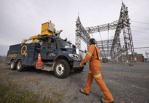 A Hydro Quebec worker walks back to his truck after inspecting a substation in Delson, Quebec, October 12, 2022. (Christinne Muschi /The Globe and Mail)